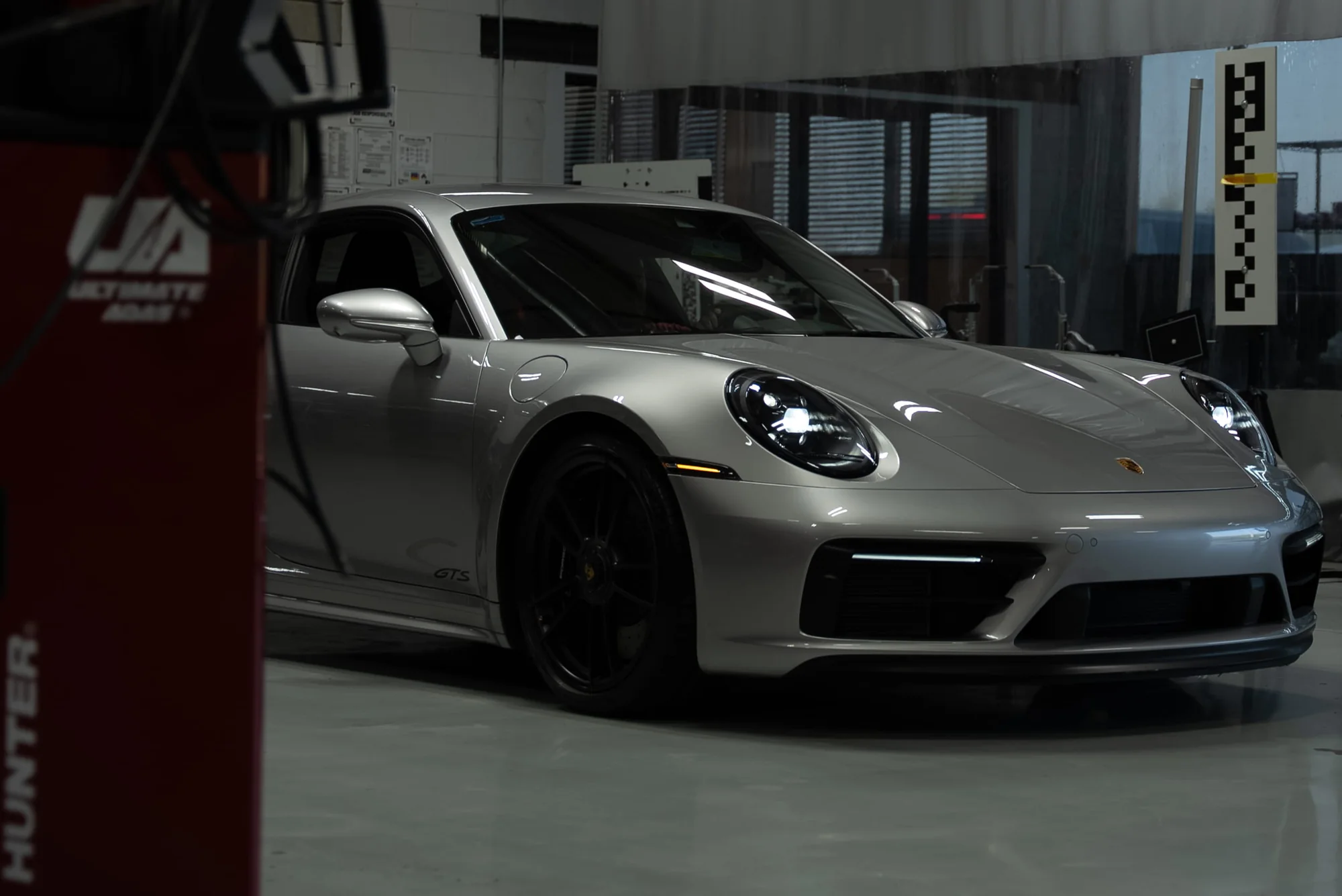 Silver Porsche 911 GTS inside the Body Builders Automotive shop