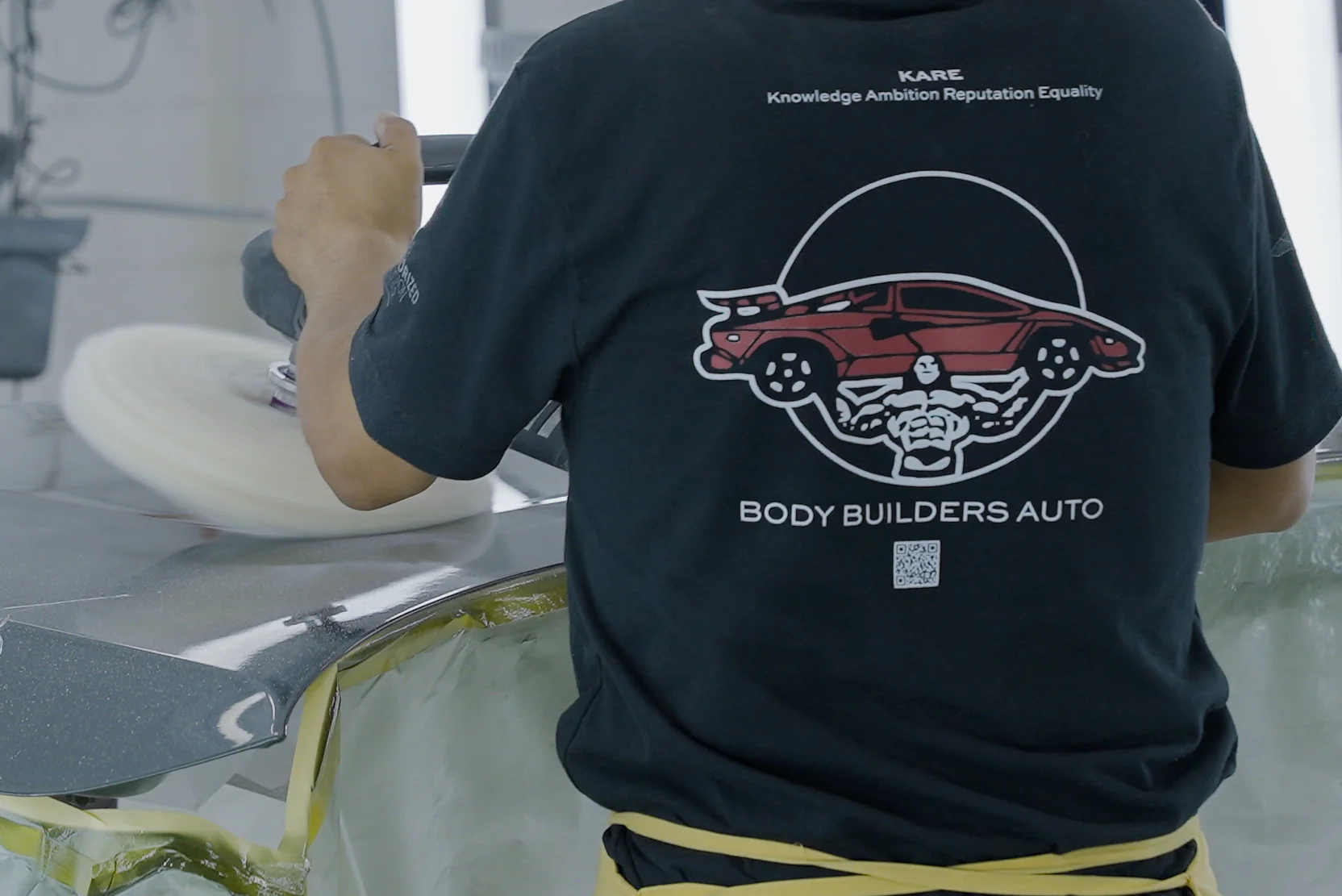 Body Builders Automotive technician polishing a freshly repaired panel